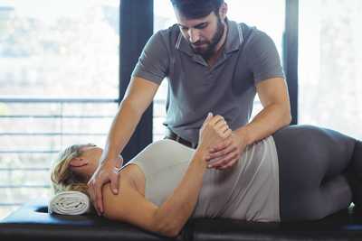 Chiropractor setting up a spinal adjustment to help patient find relief