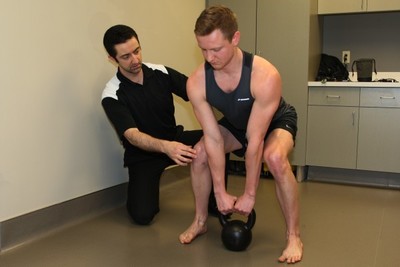 instructor assisting patient on functional rehabilitation