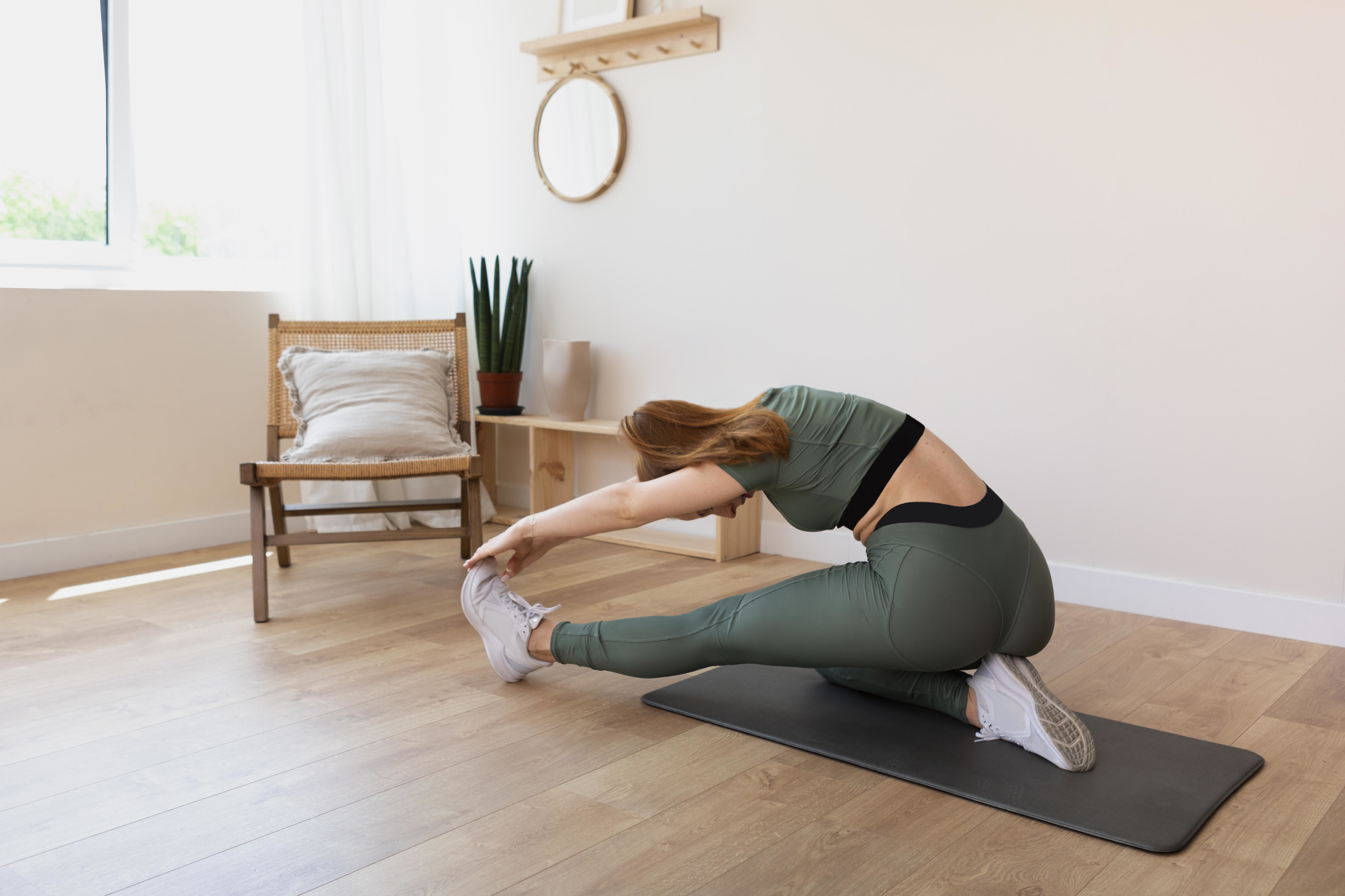 full-shot-woman-stretching-mat-home