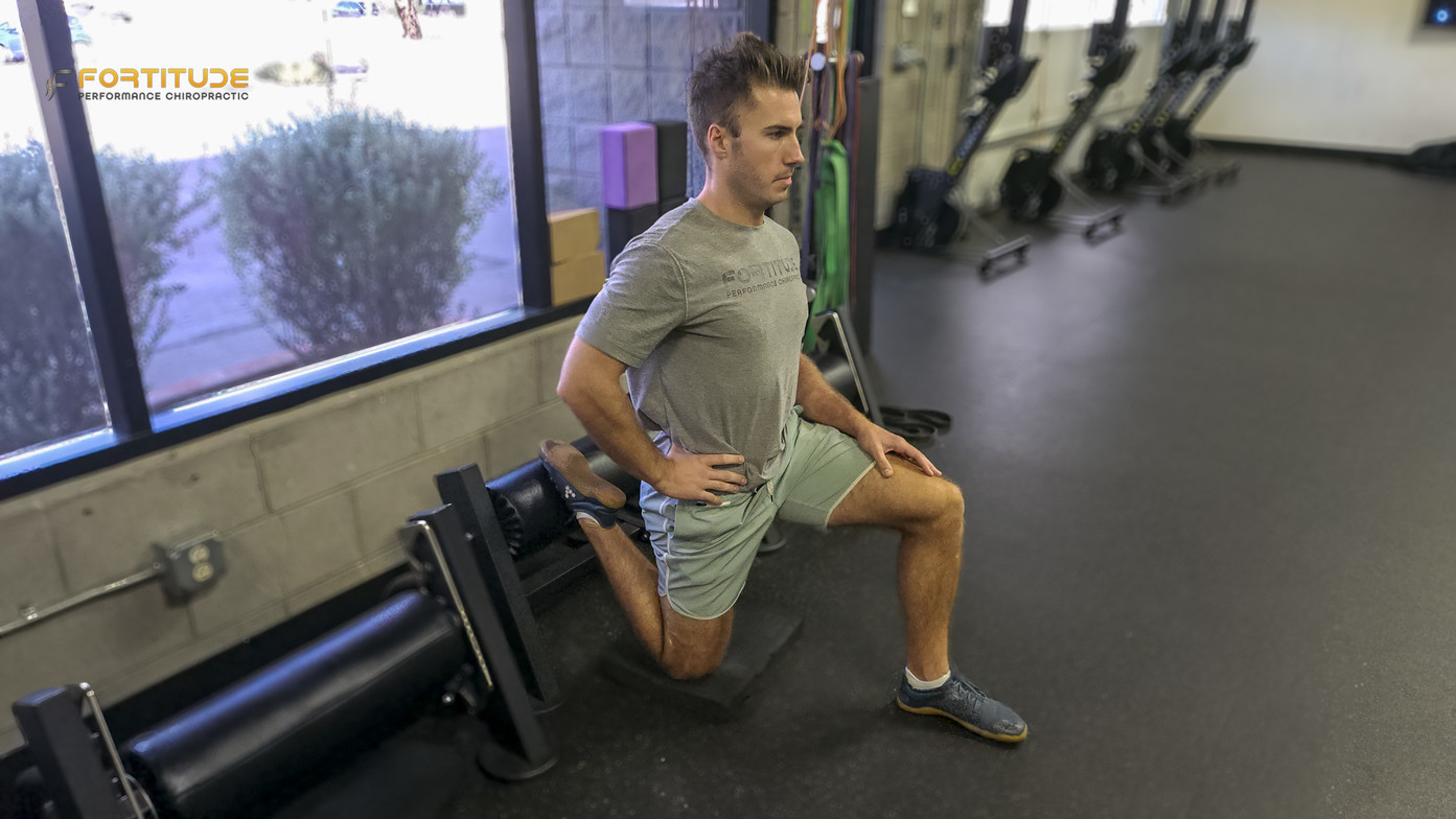 Lunge position with dumbbell and band resistance