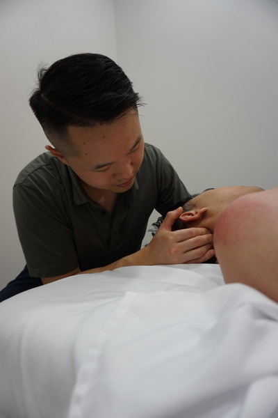 Chiropractor treating neck pain