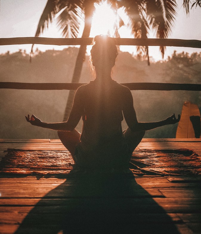 A women sitting down relaxing representing healing through the mind-body connection