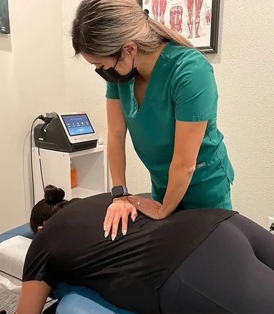 Chiropractor adjusts a patient's back