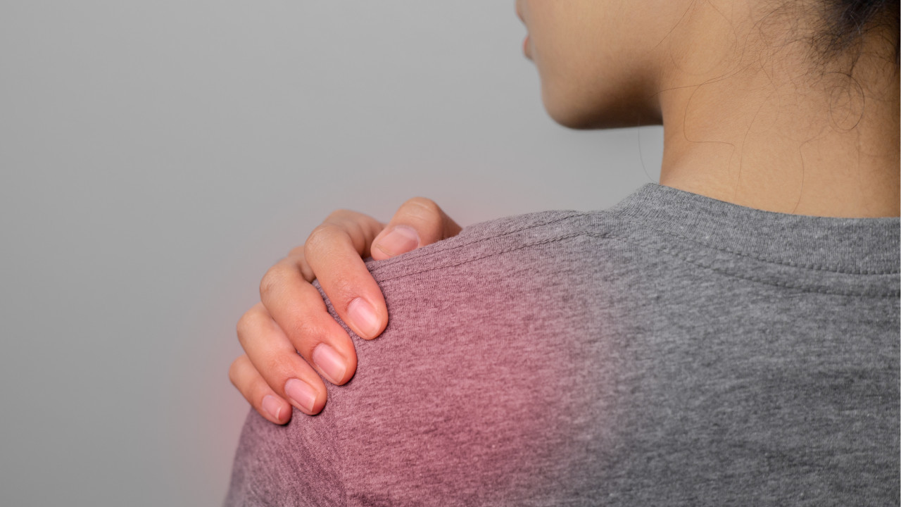 picture of woman touching her painful shoulder