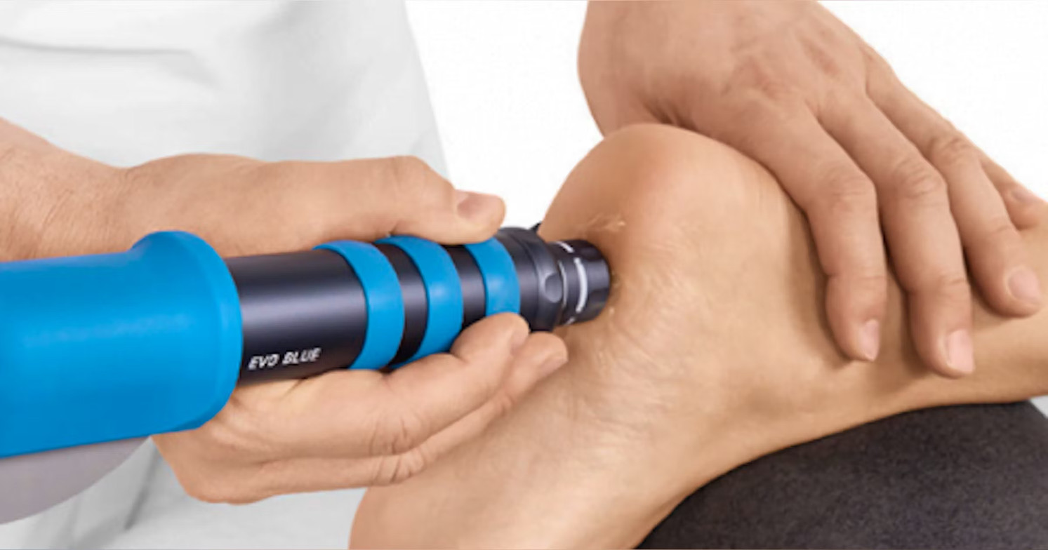 Chiropractor applying radial shockwave therapy to a patient’s heel for plantar fasciitis or neuropathy treatment at Spine Align Chiropractic & Wellness in Huntsville.