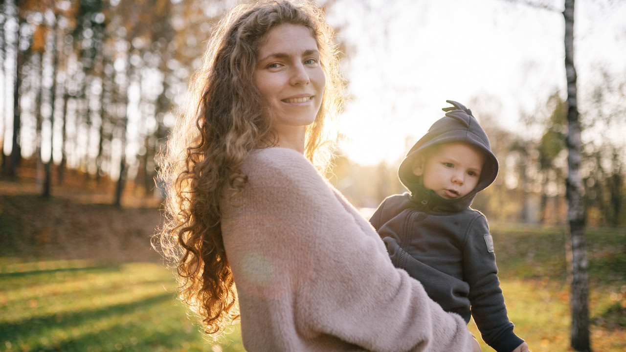 a lady carrying a child on her hip 