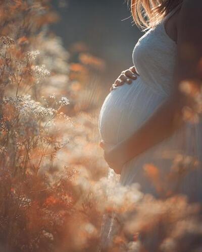 pregnant women standing in field