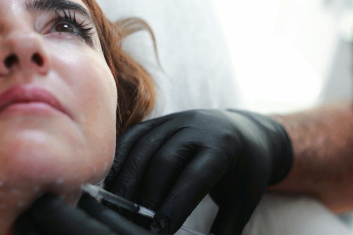 Medical provider performing Botox injection to lower face