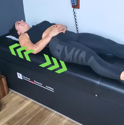 spinal traction decompression being performed on female athlete