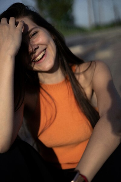 Woman in orange shirt smiling