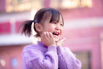 Happy girl celebrating that she met her speech therapy and occupational therapy goals.