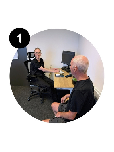 Chiropractor Adam welcoming a new patient during an initial consultation at Handsworth Chiropractic Clinic.