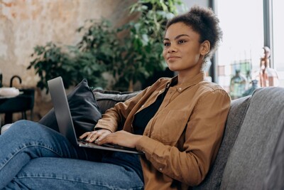 Woman attending a virtual therapy session from home using a laptop.
