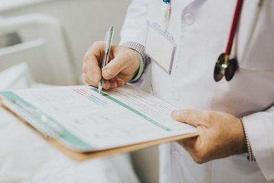 Audiologist writing down medical history