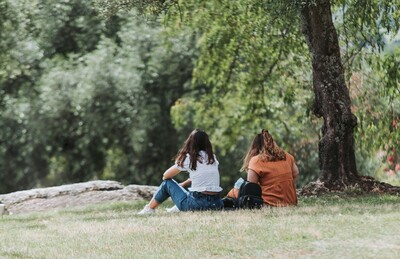 Two people sitting together outdoors during a counselling conversation. 