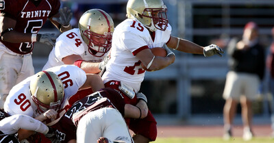 Football players playing a game which has a high risk for concussion injuries.