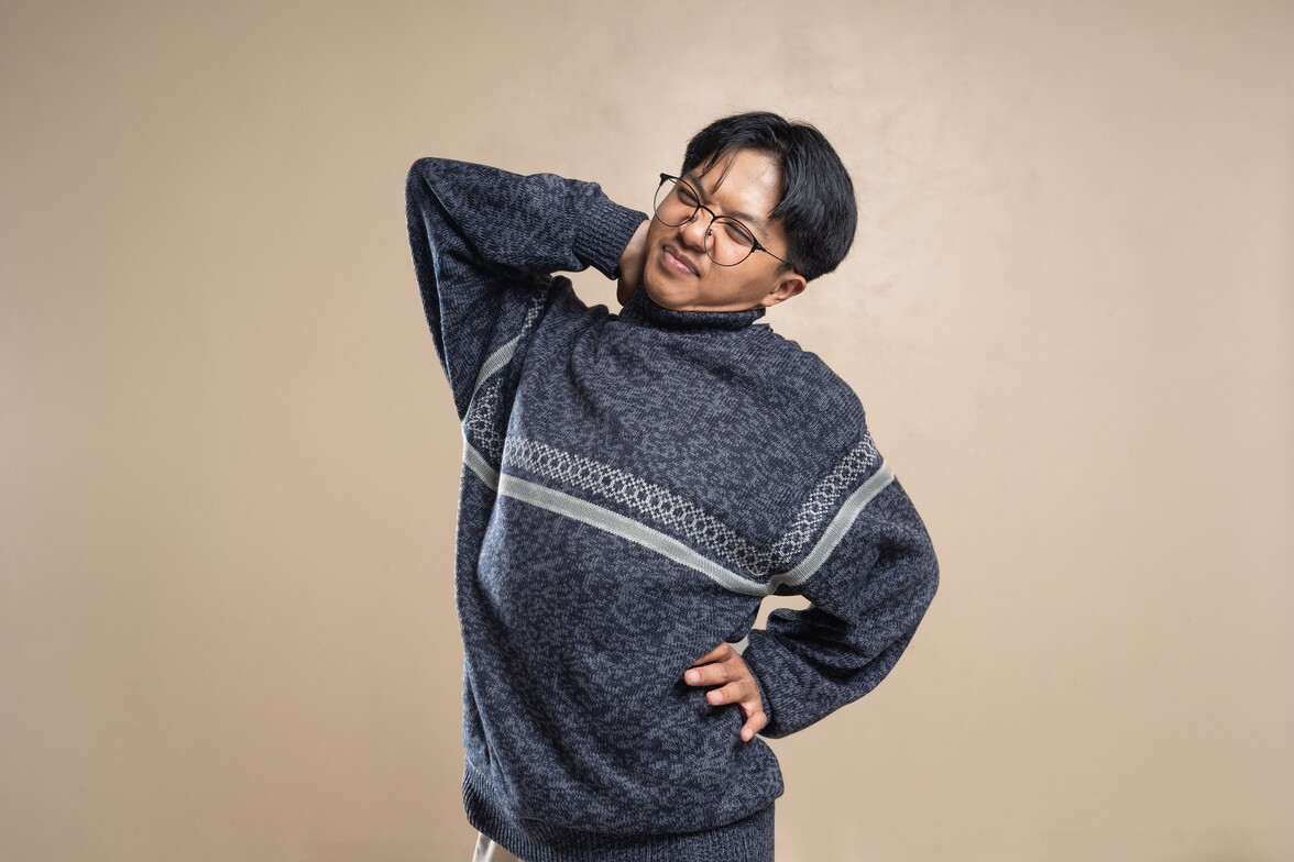 A man holding his hip in pain because it's making noise