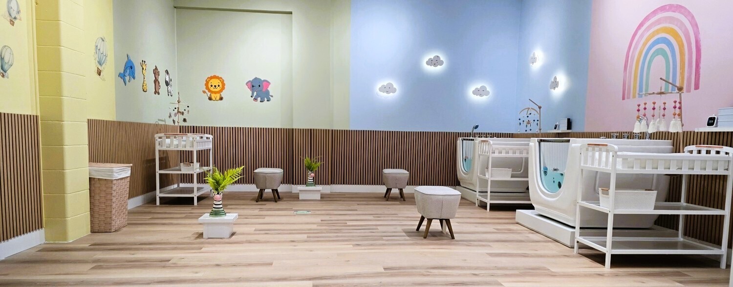 The bright baby spa room at Dolphin Dive with float tubs and change stations