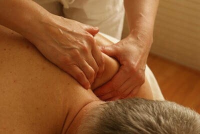 Registered massage therapist treating neck pain
