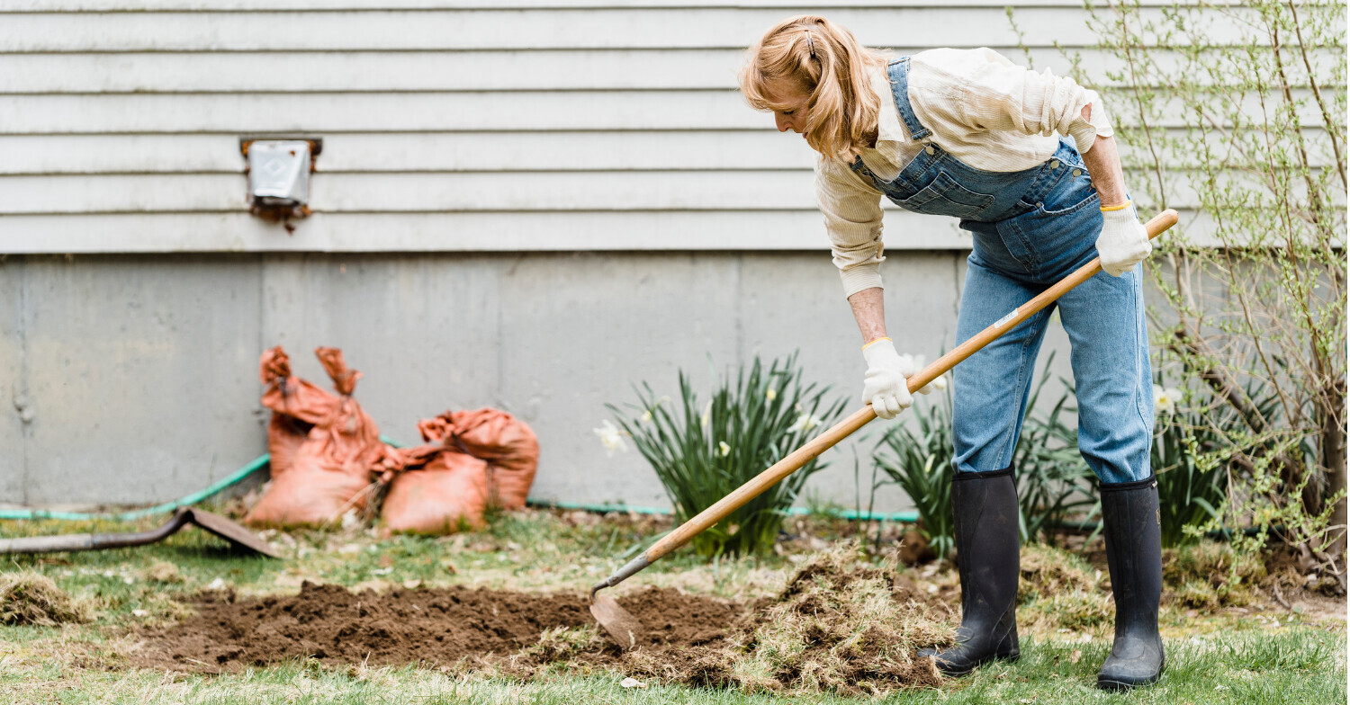 woman bending over gardening using a tool. peachtree city chiropractic restorative care chiropractic center