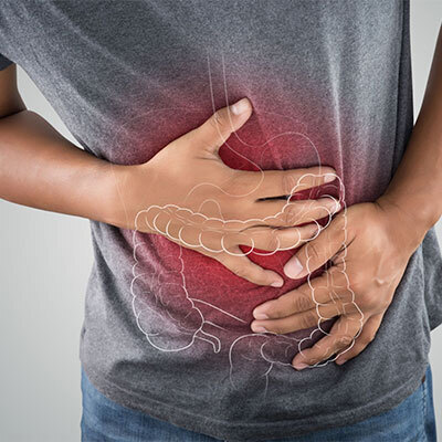 man-in-grey-shirt-with-stomach-pain