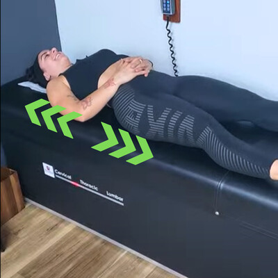 female fitness patient getting spinal traction/decompression for neuropathy