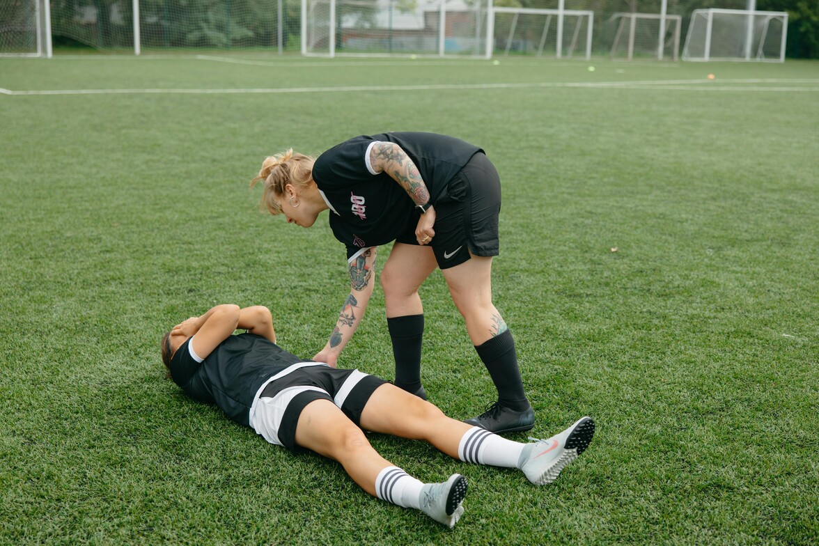 girl on ground after soccer head injury