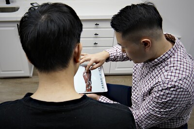 Male chiropractor providing a consultation