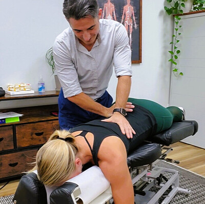 dr mike sebastian of green space health giving a chiropractic adjustment to a patient with scoliosis