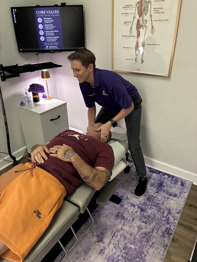 Dr. Hughes adjusting a patient's neck to relieve headaches.