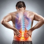 Man grabs low back in pain