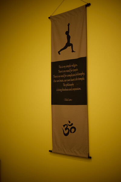 Inspirational poster in front of yellow clinic wall