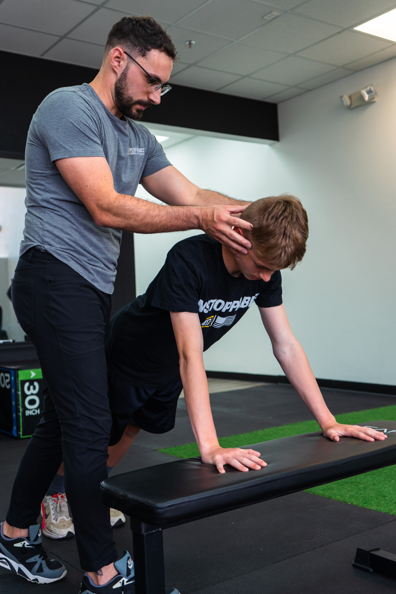Patient working with a provider at a sports chiropractic clinic in Springfield, MO during a functional movement assessment