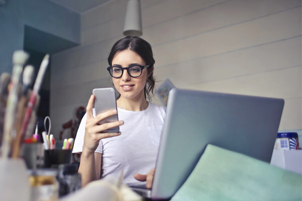Woman looking at her phone after being ghosted in modern dating