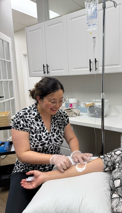 Female naturopath administrating an IV