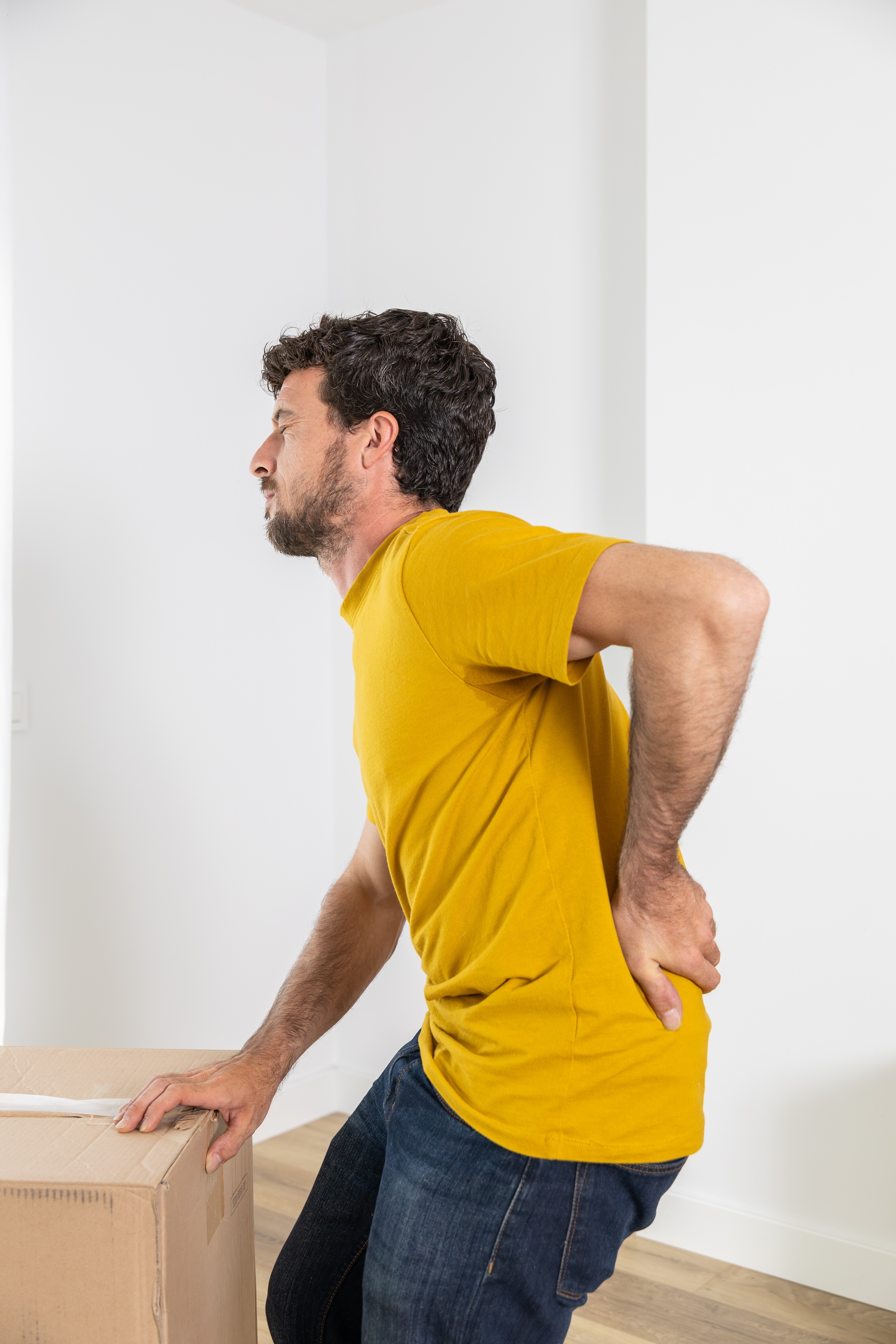 person-holding-lower-back-pain-lifting-box