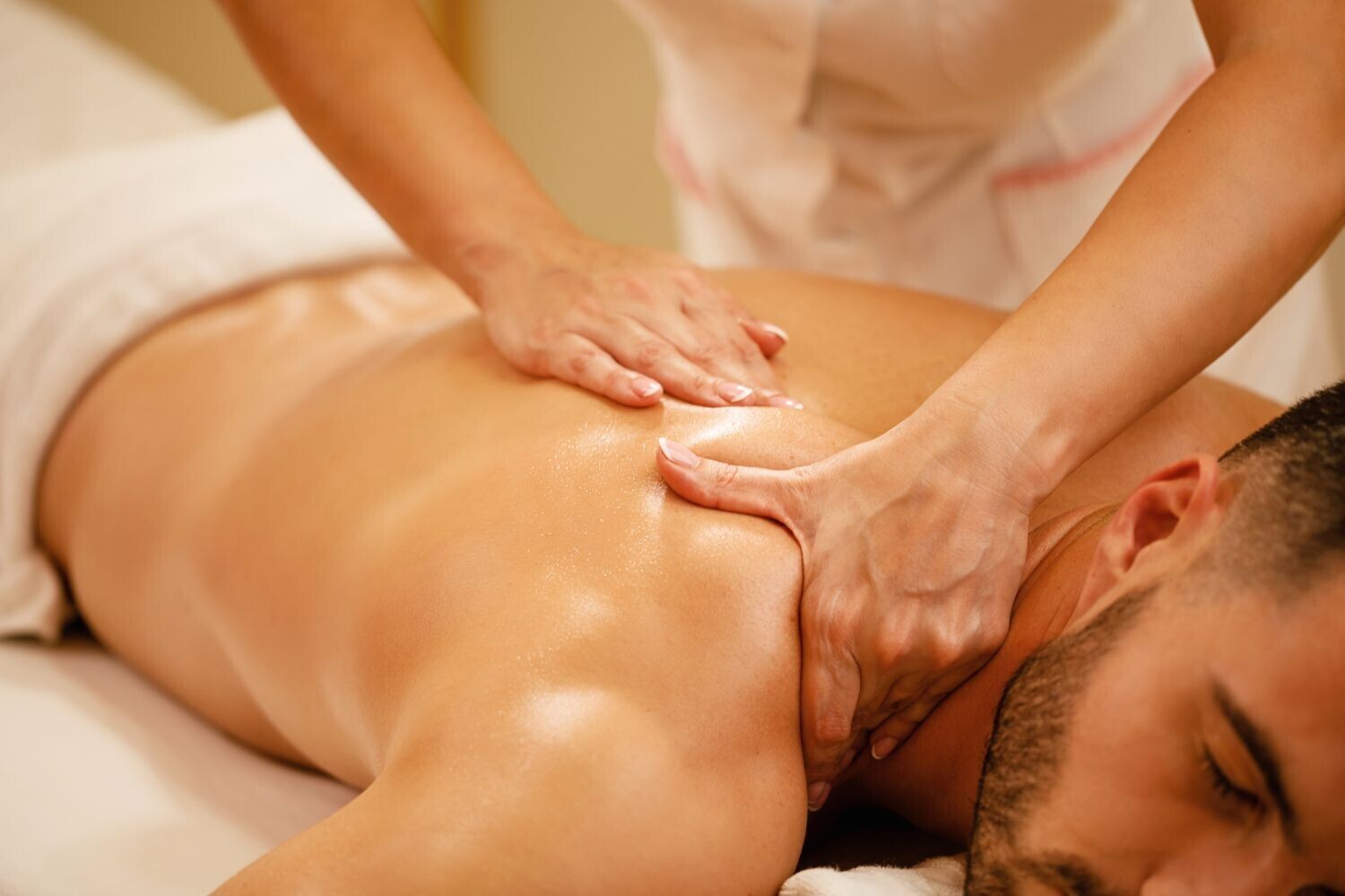 A Registered Massage Therapist working on a client's shoulders