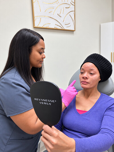 Provider assessing patient concerns while using a mirror. 