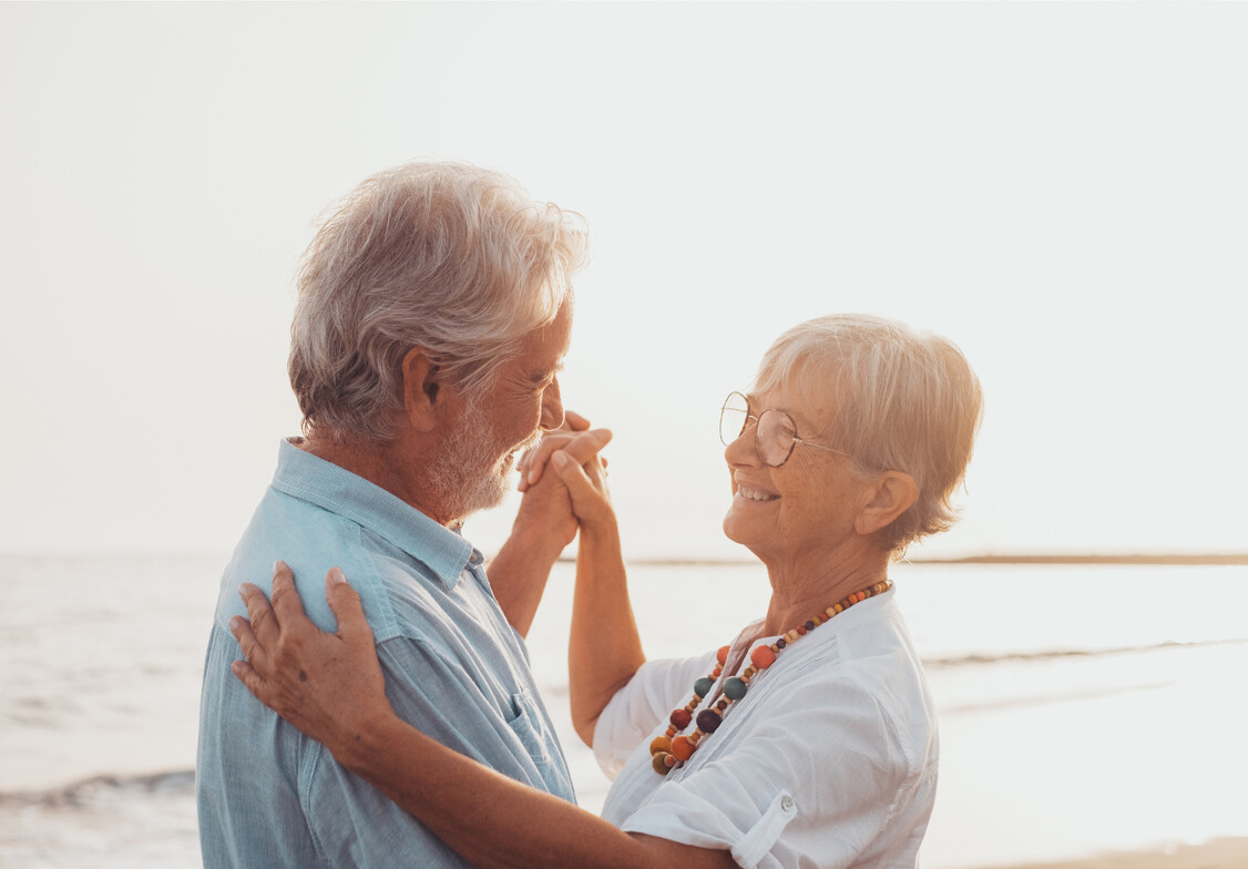 senior couple celebrating neuropathy relief at a beach in Long Beach, California