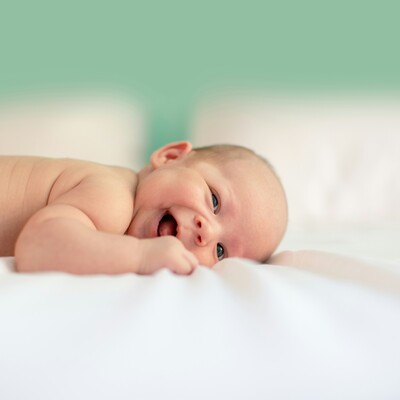 Baby lying on his tummy and smiling