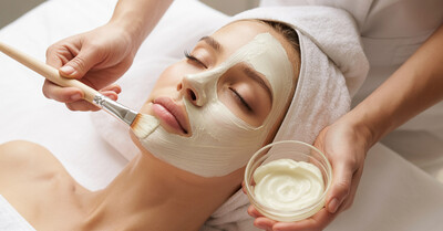 Woman getting a facial with a product mask on her face