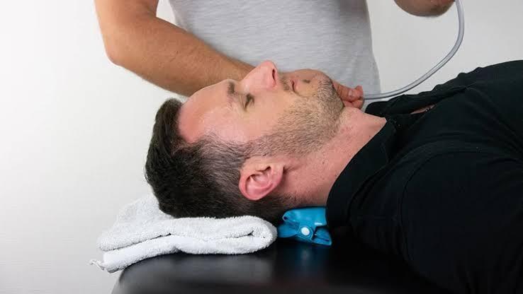 Patient practicing a clinician-guided neck exercise.