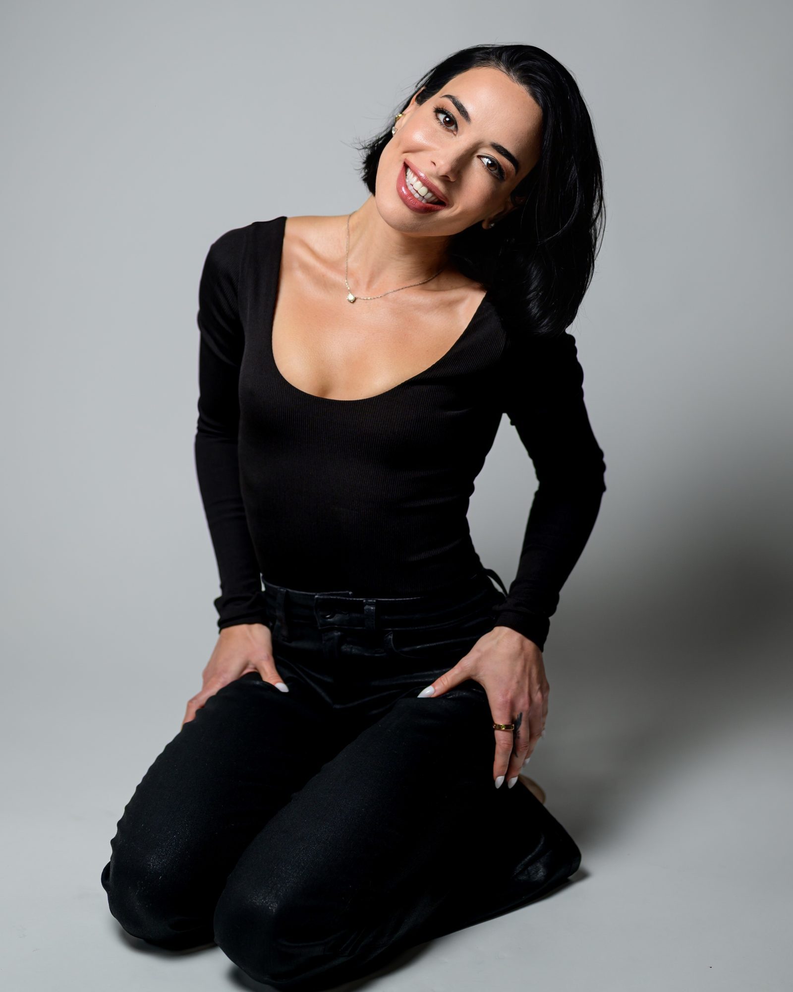 Sofia Gadelov in black, seated on the studio floor